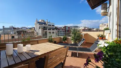 a balcony with a wooden table and a view of a city at Opening Doors Sagrada Familia in Barcelona