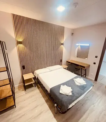 a bedroom with a bed and a desk in it at COLIBRI in Calella