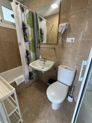 a bathroom with a toilet and a sink at COLIBRI in Calella
