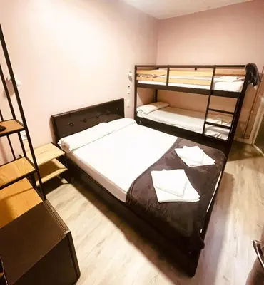 a bedroom with two bunk beds with white sheets at COLIBRI in Calella