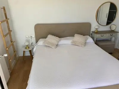 a bedroom with a large white bed with a mirror at Villa Maioli in Olivella