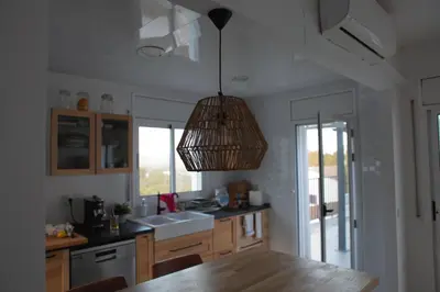 a kitchen with a basket hanging from the ceiling at Villa Maioli in Olivella