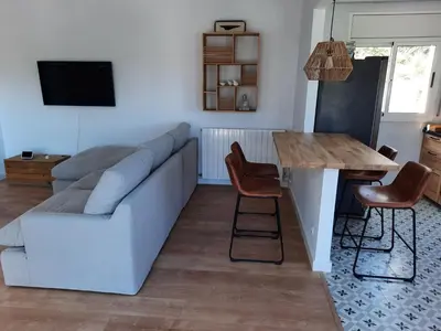 a living room with a couch and a table at Villa Maioli in Olivella