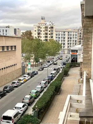 a street with cars parked on the side of a road at APARTAMENTO BARCELONA in Barcelona