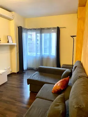 a living room with a couch and a window at APARTAMENTO BARCELONA in Barcelona