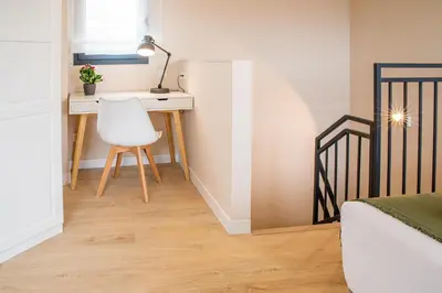 a bedroom with a desk and a chair and a bed at Barcelona Touch Apartments - Progres in Hospitalet de Llobregat