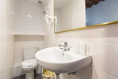 a white bathroom with a sink and a toilet at Barrio Gotico Apartments Ferran in Barcelona