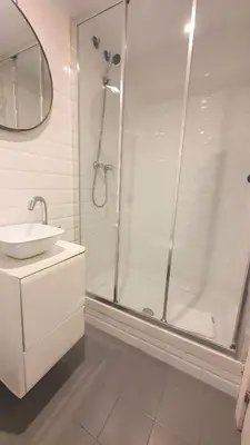 a white bathroom with a shower and a sink at Barrio Gotico Apartments Ferran in Barcelona
