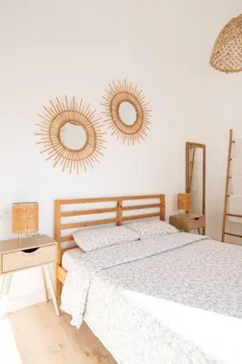 a bedroom with a bed and two mirrors on the wall at Apartamento NUEVO con encanto en SAGRADA FAMILIA in Barcelona