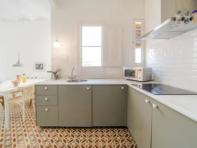 a kitchen with a sink and a counter top at White penthouse in Barcelona