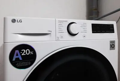 a white washing machine with two labels on it at Stay U-nique Villa Portimar in Arenys de Mar