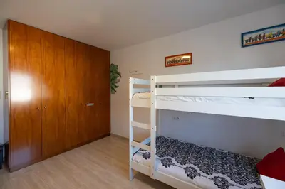 a bedroom with two bunk beds and a closet at Stay U-nique Villa Portimar in Arenys de Mar