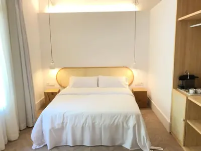 a bedroom with a large bed with white sheets at The MO House in Barcelona