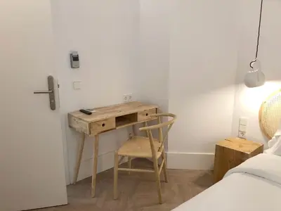 a desk in a bedroom with a bed and a chair at The MO House in Barcelona