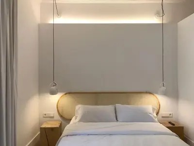 a bedroom with a bed with two lights above it at The MO House in Barcelona
