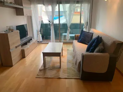 a living room with a couch and a coffee table at APARTAMENTO construcción nueva BARCELONA - CALELLA in Calella