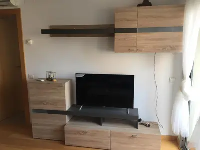 a living room with a flat screen tv on a wall at APARTAMENTO construcción nueva BARCELONA - CALELLA in Calella