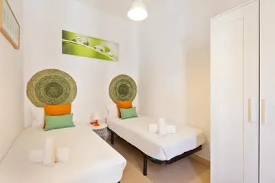 two beds in a room with white walls at Stay U-nique Apartments Mistral in Barcelona