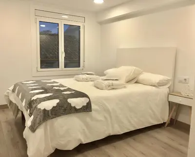 a bedroom with a large bed with a window at MonResidence Cavall Bernat in Manresa