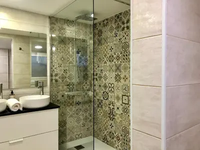a bathroom with a glass shower with a sink at MonResidence Cavall Bernat in Manresa