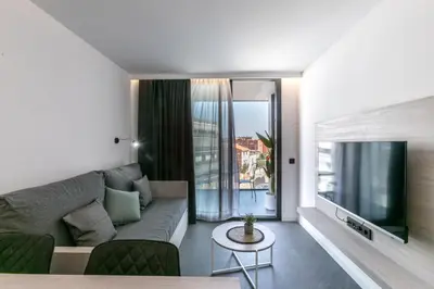 a living room with a couch and a tv at Art Apartments BCN in Castelldefels