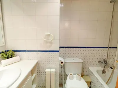 a bathroom with a toilet and a sink and a tub at Apartamento Burdeos by Hello Homes Sitges in Sitges