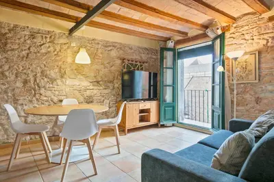 a living room with a table and chairs and a couch at Alcam Santa Monica in Barcelona