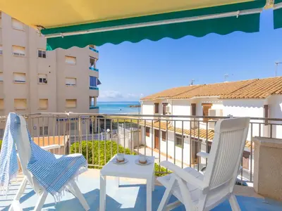 two chairs and a table on a balcony with the ocean at Apartment Blue Sea by Interhome in Cunit