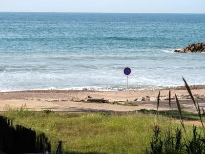 a sign on a beach next to the ocean at Apartment Blue Sea by Interhome in Cunit