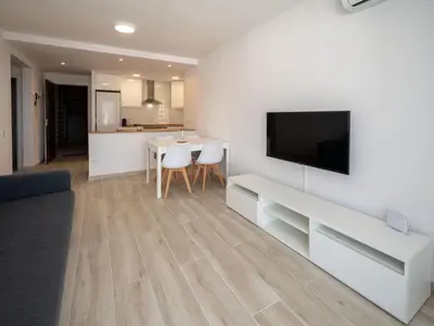 a living room with a flat screen tv on a wall at Apartment Blue Sea by Interhome in Cunit