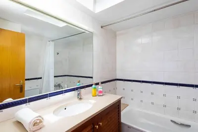 a bathroom with a sink and a tub and a mirror at Mediterranean villa with pool near barcelona in Cabrera de Mar