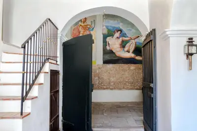 a hallway with stairs and a painting on the wall at Masia Victoria in Sant Pere de Ribes