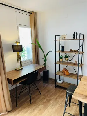 a room with a desk and a table and a window at Stunning 2 bedroom Apartment with great design Sitges centre beach in Sitges