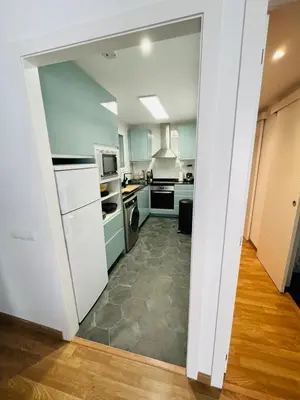 a kitchen with a door open to a kitchen with appliances at Stunning 2 bedroom Apartment with great design Sitges centre beach in Sitges