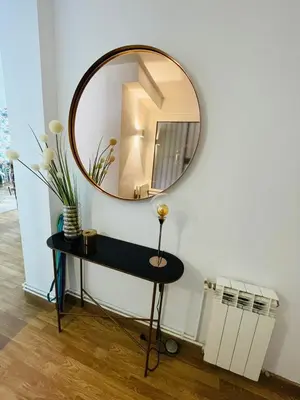 a mirror on a wall next to a black table at Stunning 2 bedroom Apartment with great design Sitges centre beach in Sitges