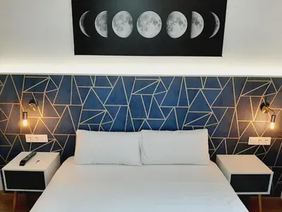 a bedroom with a bed and a wall with phases at Hostal Laia by gaiarooms in Barcelona