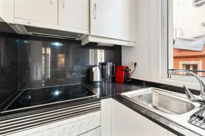 a kitchen with a stove top oven next to a sink at Lodging Apartments Barceloneta Beach Studio 12 in Barcelona