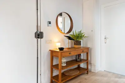 a hallway with a wooden table and a mirror at Lodging Apartments Barceloneta Beach Studio 12 in Barcelona