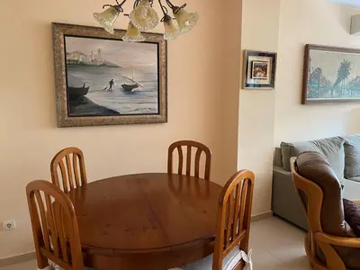 a dining room with a wooden table and chairs at Sitges Living Apartment in Sitges