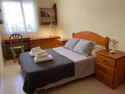 a bedroom with a bed with two towels on it at Sitges Living Apartment in Sitges