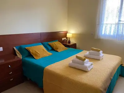 a bedroom with two beds with towels on them at Sitges Living Apartment in Sitges