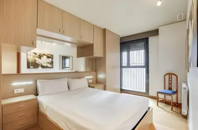 a bedroom with a large white bed and a window at Stay U-nique Apartments Diagonal Mar in Barcelona
