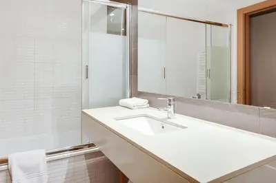 a bathroom with a sink and a mirror at Stay U-nique Apartments Diagonal Mar in Barcelona