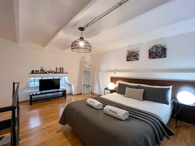 a bedroom with a large bed with two pillows on it at Stay U-nique Apartments Tordera in Barcelona