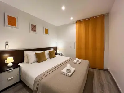 a bedroom with a large bed with towels on it at Stay U-nique Apartments Tordera in Barcelona