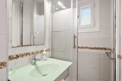 a white bathroom with a sink and a shower at Stay U-nique Apartments Hospital Clinic in Barcelona
