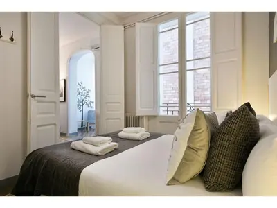 a bedroom with a bed with pillows and a window at Stay U-nique Apartments Napols I in Barcelona