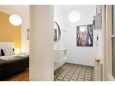 a bedroom with a bed and a mirror on the wall at Stay U-nique Apartments Napols I in Barcelona