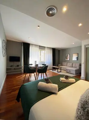 a bedroom with two beds and a living room at Stay U-nique Apartments Passeig de Gracia II in Barcelona