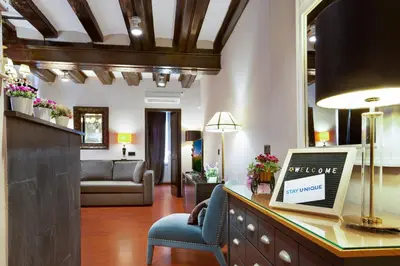 a living room with a desk with a laptop on it at Stay U-nique Apartments Carretes in Barcelona